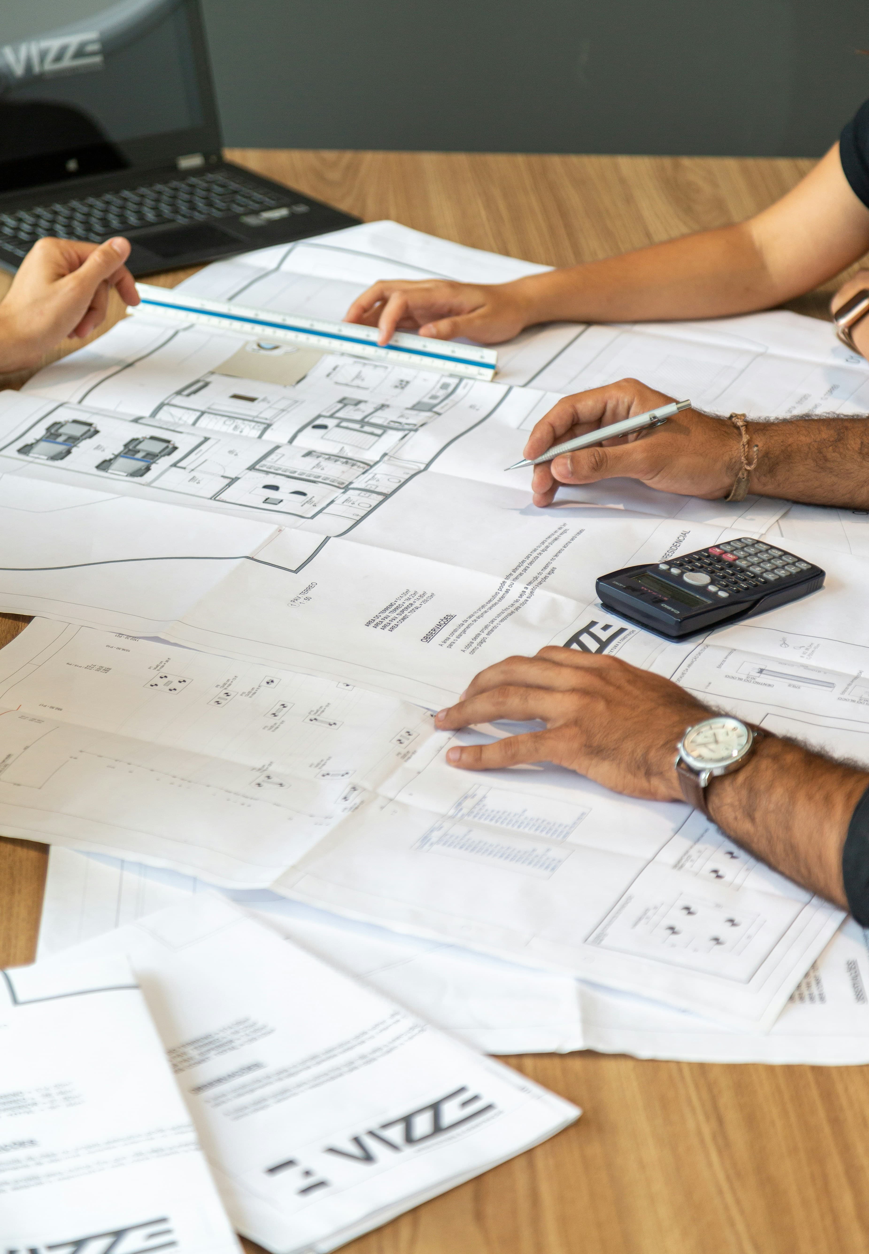 Architecten werken aan tekeningen op een tafel
